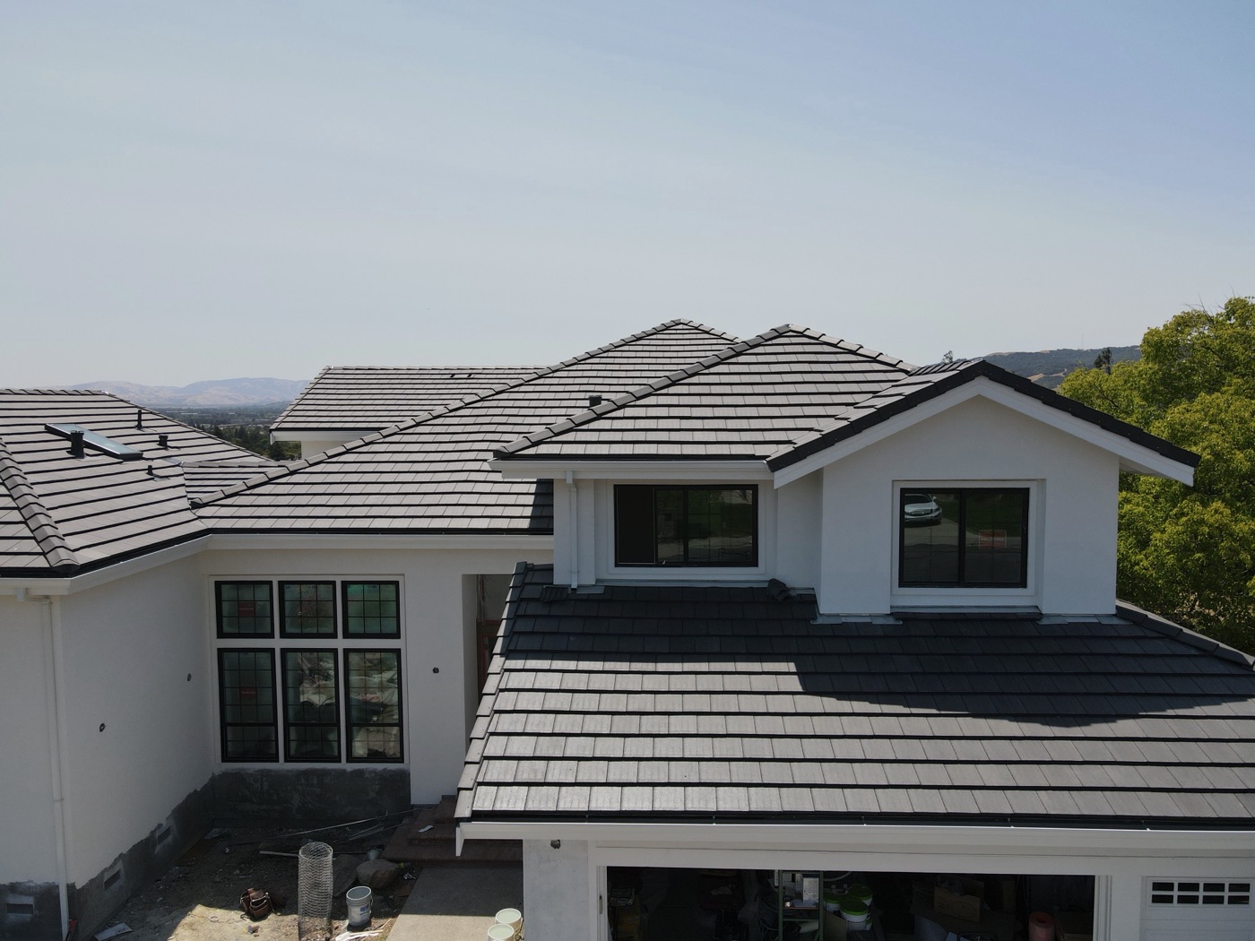 New flat concrete tile roof on a two-story home