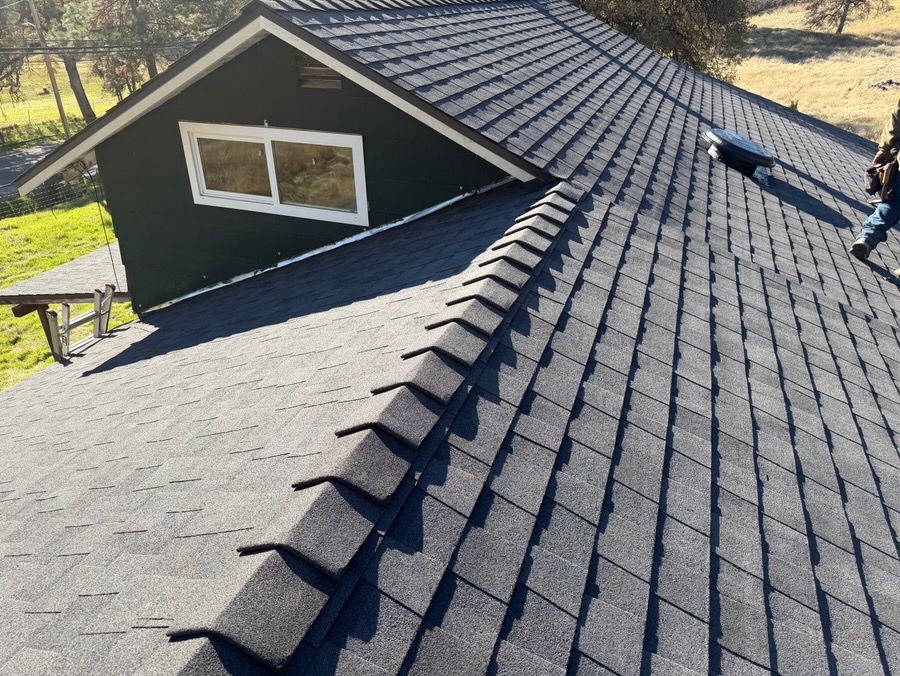 New shingles meeting the siding at a dormer