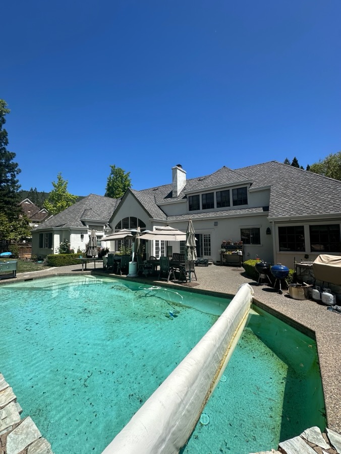 Shingle re-roof overlooking a backyard pool